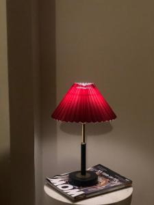 a red lamp sitting on top of a magazine at Nhà 5 PM in Da Thien