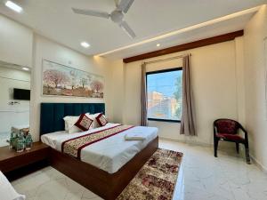 a bedroom with a large bed and a window at SR Palace - Best Hotel in Vrindavan Near Prem Mandir and Iskcon Temple with Private Parking in Vrindāvan +50 photos