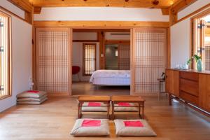 a bedroom with a bed and a table in a room at soyeonjae 소연재 in Gyeongju +74 photos