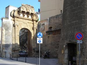 a gate to a building with signs in front of it at Case Porta San Salvatore Sciacca in Sciacca