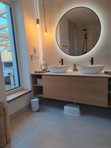 a bathroom with two sinks and a large mirror at Chata Za Studeným potokom in Habovka +30 photos