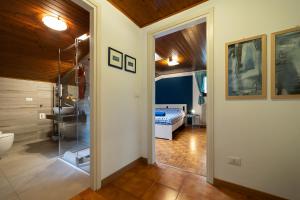 a bathroom with a glass door leading to a bedroom at Alla Casa Medievale in Cividale del Friuli
