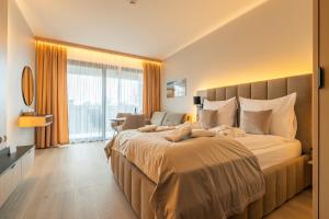 a bedroom with a large bed with a large window at Your Holidays Infinity A233 in Międzyzdroje