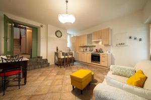 a living room and kitchen with a couch and a table at Alla Casa Medievale in Cividale del Friuli