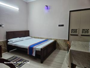 a bedroom with a bed with a cross on the wall at AJk villa in Negombo