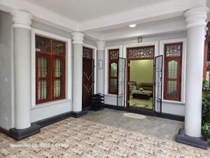 a large room with white columns and windows at AJk villa in Negombo