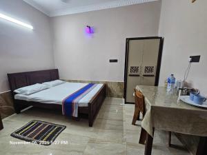 a bedroom with a bed and a table in it at AJk villa in Negombo