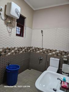 a bathroom with a shower and a sink and a toilet at AJk villa in Negombo