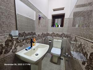 a bathroom with a sink and a toilet at AJk villa in Negombo