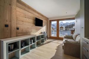 a living room with a couch and a television at Résidence Freddie in Tignes
