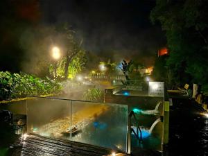 a water fountain in a park at night at H2Furnas Natur in Furnas