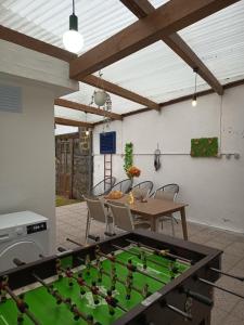 a ping pong table in a patio with a pool table at H2Furnas Natur in Furnas