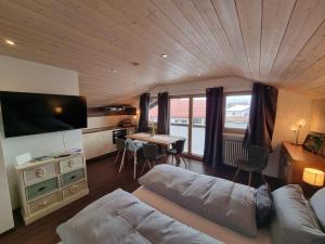 a living room with a couch and a table at Zugspitze 6 mit SAUNA in Farchant bei Garmisch-Partenkirchen in Farchant