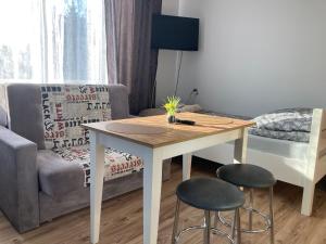 a living room with a table and two stools at Agroturystyka u Witka in Brynica Mokra +36 photos
