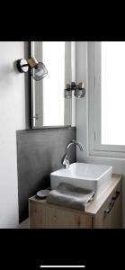 a bathroom with a white sink and a mirror at Marée Ault - Maison de ville échappée mer in Ault +19 photos