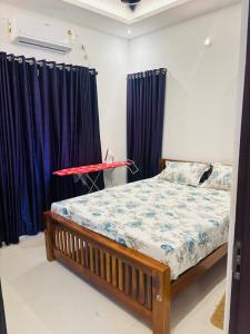 a bedroom with a bed with blue curtains at Love shore in Cochin