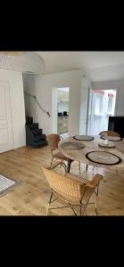 a living room with a table and chairs and stairs at Marée Ault - Maison de ville échappée mer in Ault