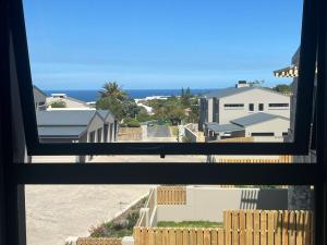 a view of the beach from a window at My Plett, Your Plett in Plettenberg Bay