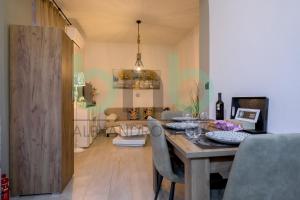 a dining room with a table with a laptop on it at Markella Lux Apartment in Alexandroupoli +45 photos