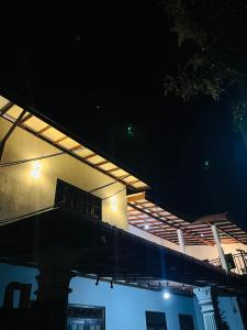 a night view of a building with a roof at Manthraa Holiday Apartment in Ratgama Hegoda