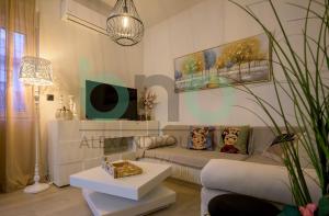 a living room with a couch and a table at Markella Lux Apartment in Alexandroupoli