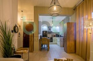 a living room with a table and a kitchen at Markella Lux Apartment in Alexandroupoli