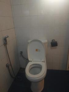 a bathroom with a white toilet in a stall at Cool feel rest and cafe in Nuwara Eliya