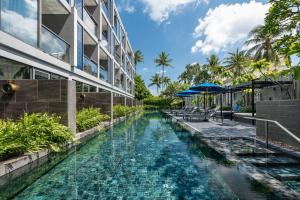 a swimming pool in front of a building at Hotel Indigo Phuket Patong by IHG in Patong Beach