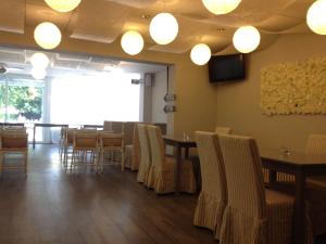 a dining room with tables and chairs and lights at Apartament L'Ast in Banyoles +13 photos