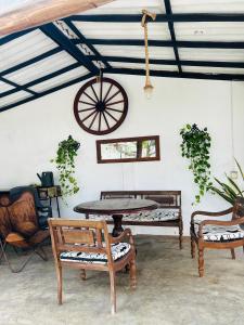 a table and chairs in a room with a ceiling at VILLA No34 HIKKADUWA in Hikkaduwa