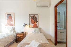 a bedroom with two beds and a mirror at Hospedaria Portuguesa in Alpiarça +61 photos