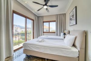 a bedroom with a bed and a large window at Carrington Holidays in Kyrenia +253 photos