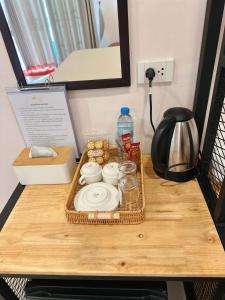 a tray with a plate and a bottle of water on a table at NICHA Cafe' & Resort in Ban Thap Chek Ha