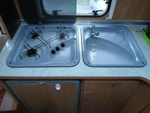 two sinks in an rv with two bugs in them at La Ventana - Jardin & Parking in Étretat +12 photos