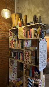 a book shelf with books on top of it at Shelter Hostel Malang in Malang