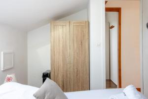 a bedroom with a wooden wardrobe and a bed at Le Chalet Panoramique Jaccuzi Parking Vue Montagne in Munster