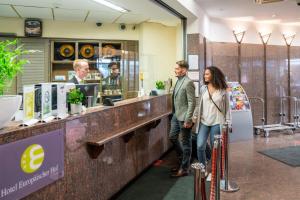 a man and woman standing at the counter of a coffee shop at Europäischer Hof in Munich +17 photos