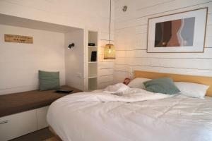 a bedroom with a large white bed in it at Lodges de Camargue in Port-Saint-Louis-du-Rhône