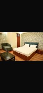 a bedroom with a bed and a coffee table at Ramaland in Faizābād