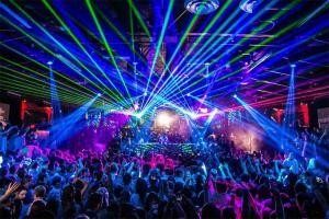 a crowd of people dancing at a nightclub with lasers at Aenaon Corfu Luxury Apartments #06 - Poseidon Apartment in Ipsos