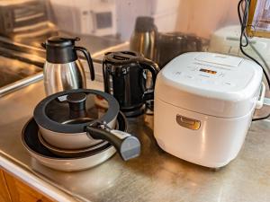 a coffee maker sitting on a kitchen counter at The M HONMACHI in Nakatsugawa