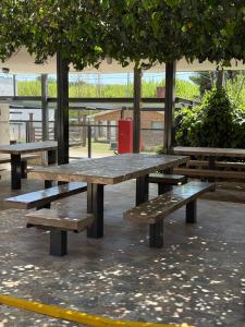 a group of picnic tables in a park at La posta del vasco in Tanti