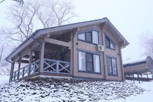a wooden cabin with snow on the ground at MATRYOSHKA HOUSE 2nd GUEST HOUSE in Yoichi