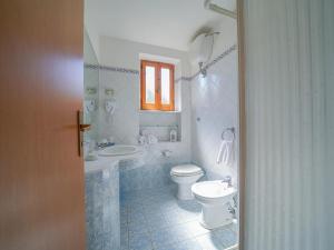 a bathroom with a toilet and a sink at Residence Villaggio Smedile in Capo Vaticano +19 photos
