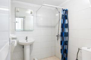a bathroom with a sink and a shower at Hôtel Mauritania Center Tangier in Tangier +54 photos