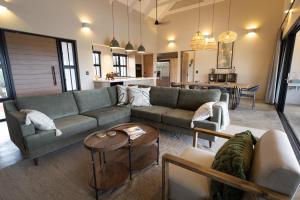 a living room with a couch and a table at Villa Kolobe in Hoedspruit