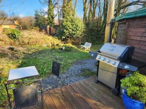 a grill on a deck next to a yard at Galtee Glamping in wooden yurt in Mitchelstown