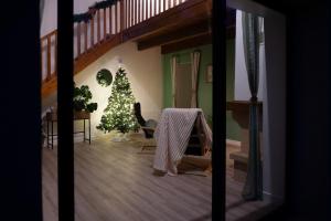 a living room with a christmas tree and a staircase at Burbujas de amor - gîte avec spa et sauna privatifs in Loubès-Bernac