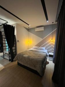 a bedroom with a large bed in a room at Skyhaus Homestay in Penampang