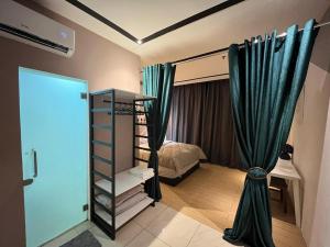 a small bedroom with a bed and a mirror at Skyhaus Homestay in Penampang